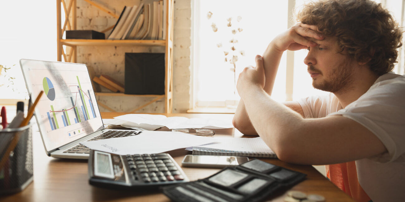 Caucasian upset and despair man watching financial and economical reports