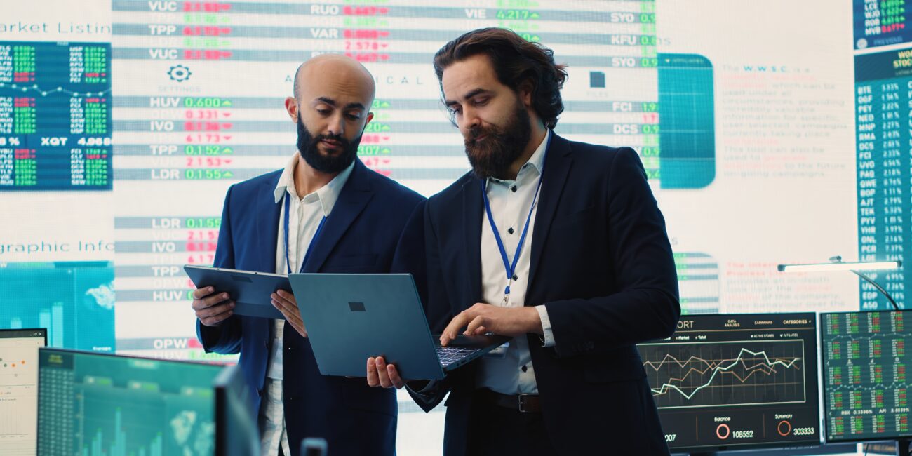 Team of investors analyzing profit amount and making decisions to fund another business project, examine big data on a huge display. Associates verifying efficiency and budget. Camera A.