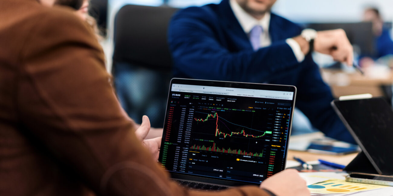 Business meeting in an office, workers discussing business affairs. Gadgets and papers with charts on the table